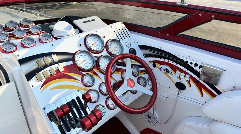  Yacht Photos Pics Dashboard of a 2007 Fountain 47 Lightning boat with gauges and red accents.