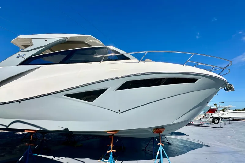  Yacht Photos Pics 2024 NX 360 Sport Coupe boat on stands under clear blue sky.