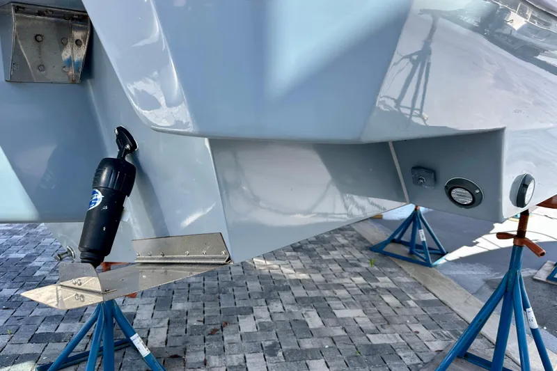  Yacht Photos Pics 2024 NX 360 Sport Coupe boat hull on stands, showcasing sleek design and components.