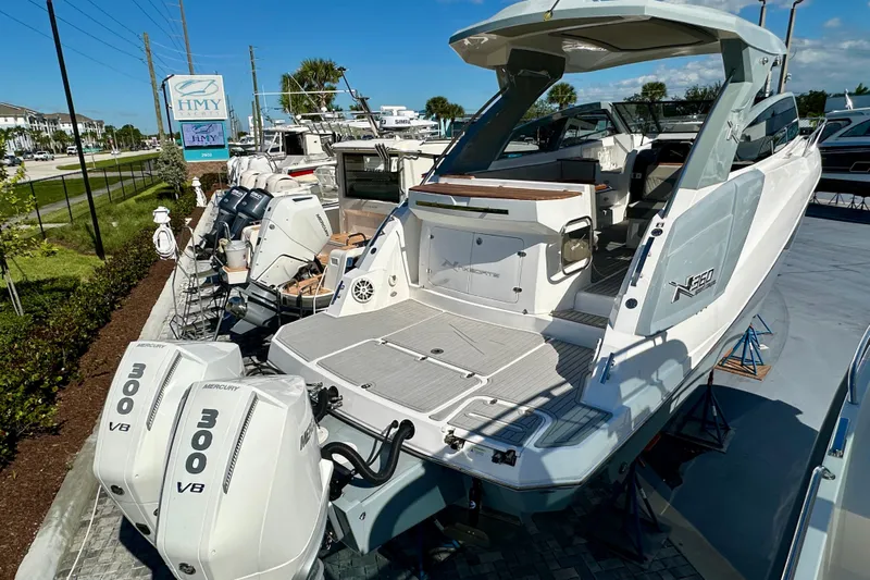  Yacht Photos Pics 2024 NX 360 Sport Coupe boat with twin Mercury 300 V8 engines at marina.