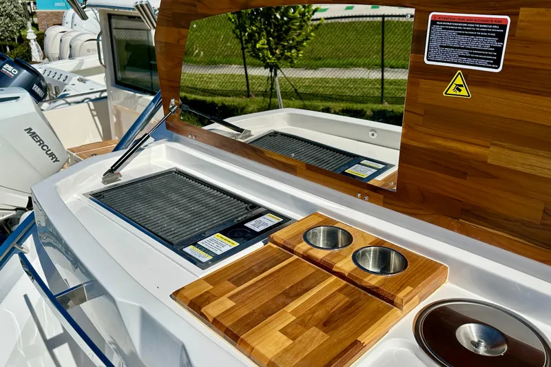  Yacht Photos Pics 2024 NX 360 Sport Coupe boat with outdoor kitchen and grill setup.