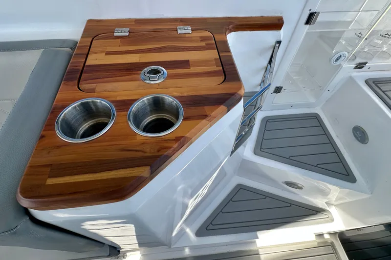  Yacht Photos Pics 2024 NX 360 Sport Coupe interior with wooden countertop and stainless steel cup holders.