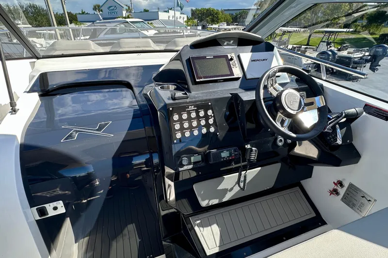  Yacht Photos Pics 2024 NX 360 Sport Coupe dashboard with steering wheel and control panel.