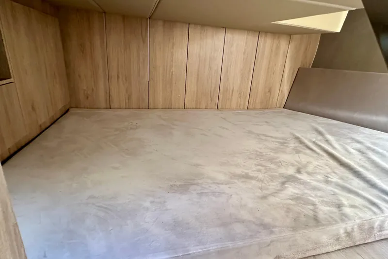  Yacht Photos Pics 2024 NX 360 Sport Coupe interior cabin with wooden paneling and spacious sleeping area.