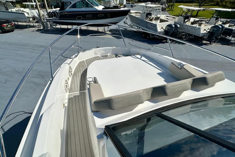  Yacht Photos Pics 2024 NX 360 Sport Coupe boat deck with cushioned seating and sleek design.