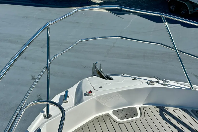  Yacht Photos Pics 2024 NX 360 Sport Coupe boat deck with stainless steel railings and non-slip flooring.