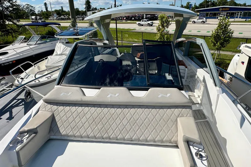  Yacht Photos Pics 2024 NX 360 Sport Coupe boat with luxurious seating and sleek design.