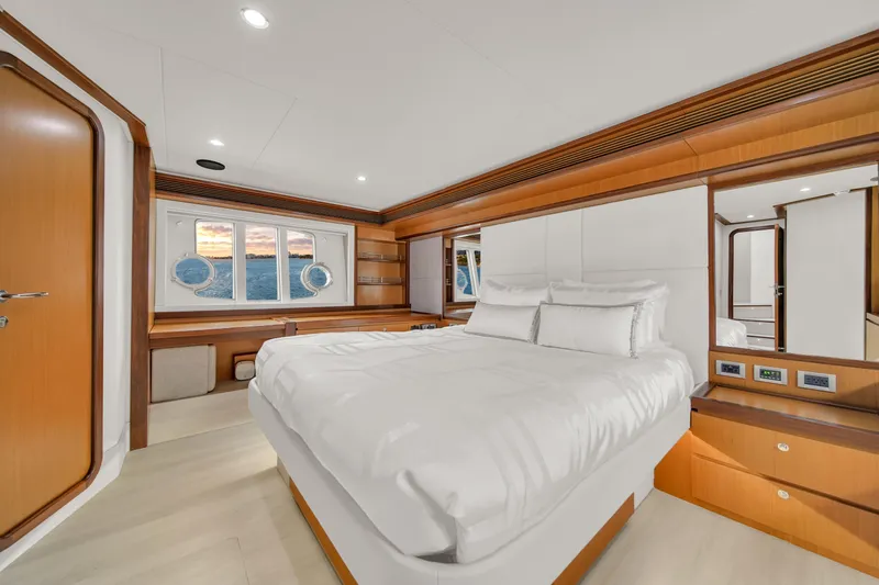 Hope Yacht Photos Pics Luxurious bedroom interior of 2011 Ferretti Yachts 660 with elegant wood finishes.