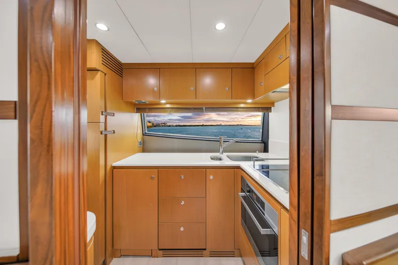 Hope Yacht Photos Pics Luxurious kitchen interior of 2011 Ferretti Yachts 660 with modern wood cabinetry and ocean view.