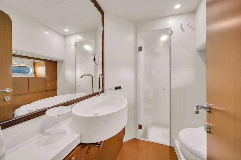 Hope Yacht Photos Pics Luxurious bathroom interior of 2011 Ferretti Yachts 660 with modern fixtures and wood accents.