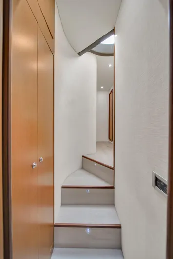 Hope Yacht Photos Pics Interior staircase of 2011 Ferretti Yachts 660, featuring sleek wooden design.