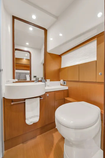 Hope Yacht Photos Pics Luxurious bathroom in 2011 Ferretti Yachts 660 with modern fixtures and wood accents.