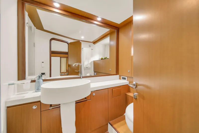 Hope Yacht Photos Pics Luxurious bathroom interior of 2011 Ferretti Yachts 660 with modern fixtures and wood accents.