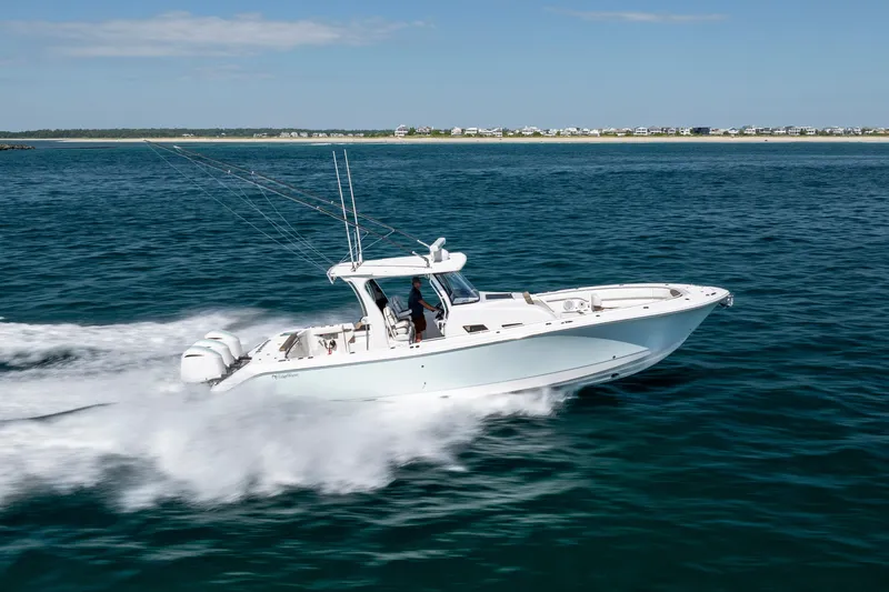  Yacht Photos Pics 2021 Edgewater 370CC boat cruising swiftly on open water.