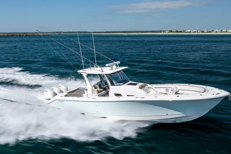  Yacht Photos Pics 2021 Edgewater 370CC boat cruising swiftly on open water.