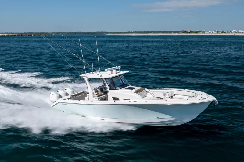  Yacht Photos Pics 2021 Edgewater 370CC boat cruising on open water, showcasing sleek design and powerful engines.