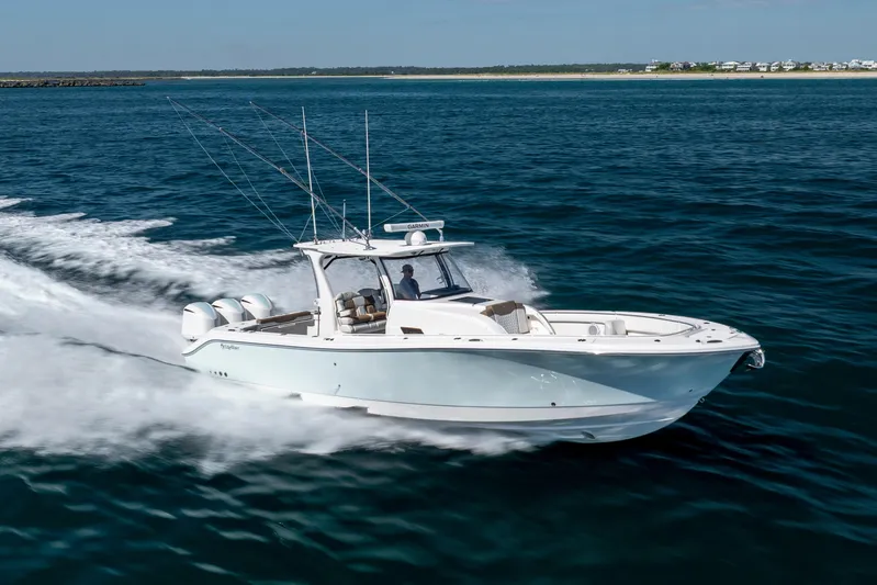  Yacht Photos Pics 2021 Edgewater 370CC boat cruising on open water, showcasing sleek design and powerful engines.