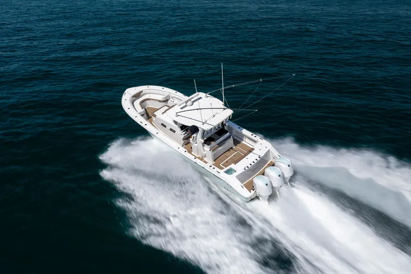  Yacht Photos Pics 2021 Edgewater 370CC boat cruising swiftly on open water.