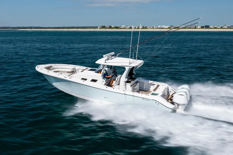  Yacht Photos Pics 2021 Edgewater 370CC boat cruising on open water, showcasing sleek design and powerful engines.