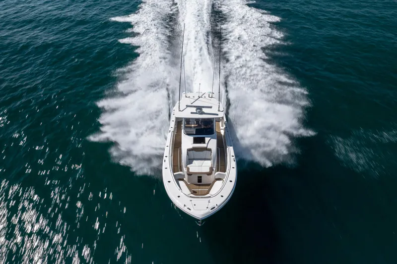  Yacht Photos Pics 2021 Edgewater 370CC boat cruising on open water, aerial view.