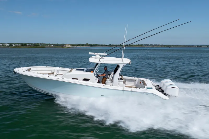  Yacht Photos Pics 2021 Edgewater 370CC boat cruising on open water, featuring dual outboard engines.