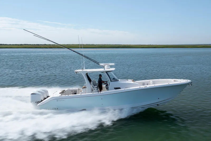  Yacht Photos Pics 2021 Edgewater 370CC boat cruising on calm water, side view.