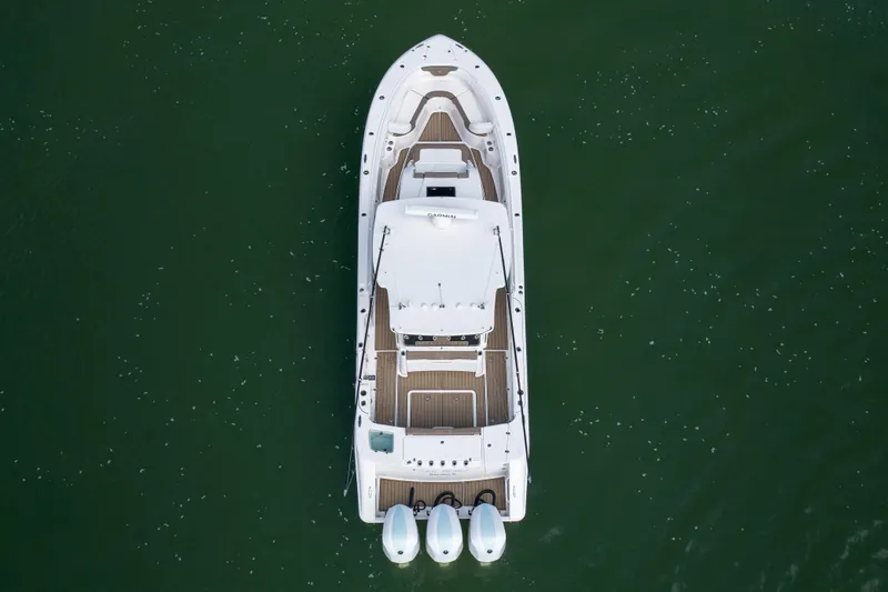  Yacht Photos Pics Aerial view of 2021 Edgewater 370CC boat on calm green water.