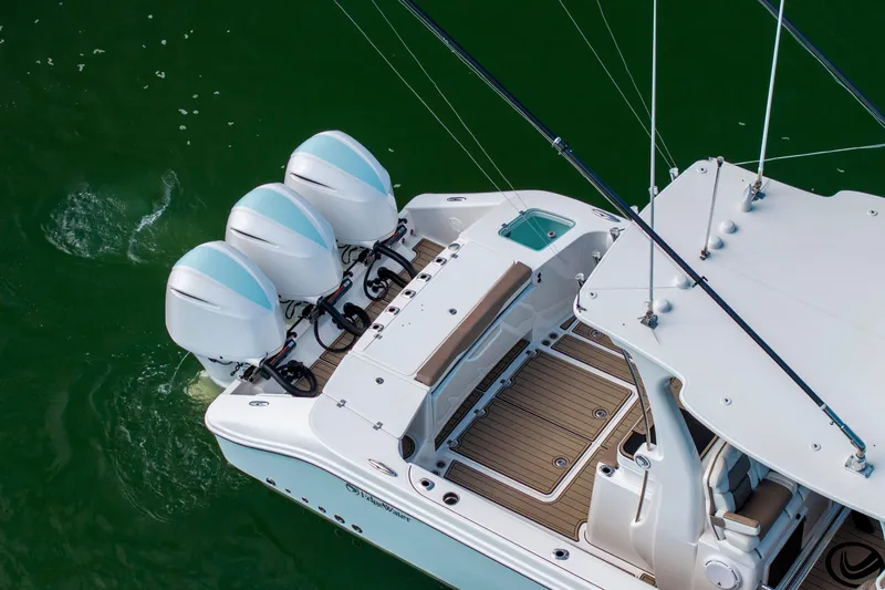  Yacht Photos Pics 2021 Edgewater 370CC boat with triple outboard engines on green water.