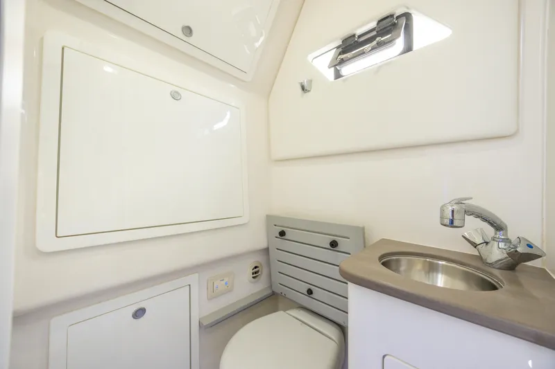  Yacht Photos Pics 2021 Edgewater 370CC boat interior bathroom with sink and toilet.