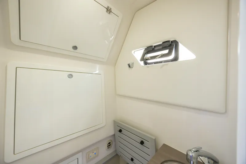 Yacht Photos Pics 2021 Edgewater 370CC cabin interior with storage compartments and a small window.