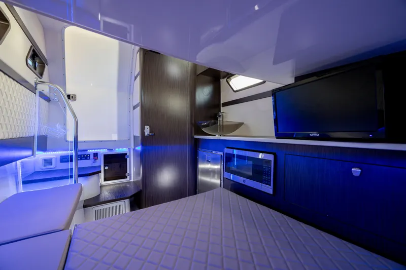  Yacht Photos Pics Luxurious interior of 2021 Edgewater 370CC boat with modern amenities and blue ambient lighting.
