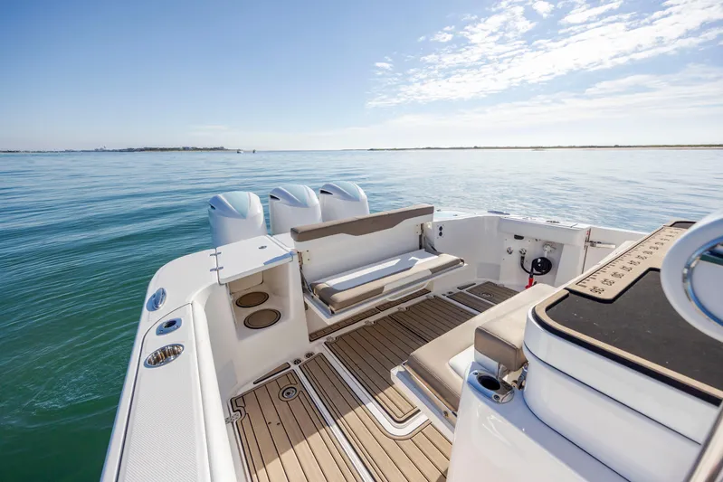  Yacht Photos Pics 2021 Edgewater 370CC boat on calm water, featuring spacious deck and seating.