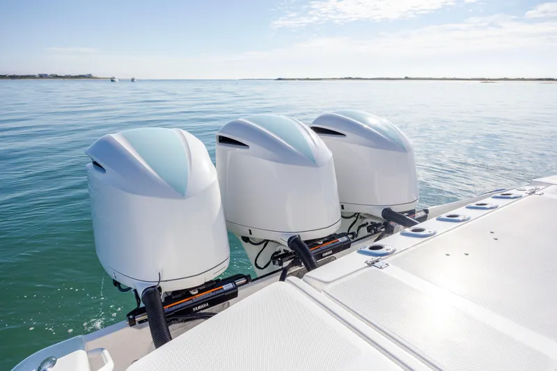  Yacht Photos Pics Triple Yamaha outboard engines on a 2021 Edgewater 370CC boat, cruising on calm waters.