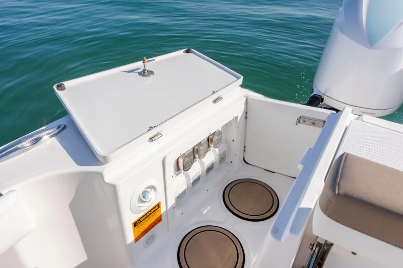  Yacht Photos Pics 2021 Edgewater 370CC boat deck with storage compartment and engine view.