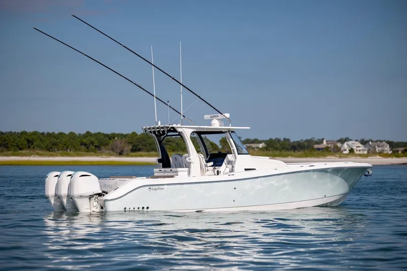  Yacht Photos Pics 2021 Edgewater 370CC boat on calm water with triple outboard engines.