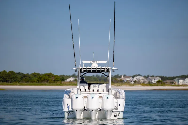  Yacht Photos Pics 2021 Edgewater 370CC boat on water, rear view with antennas, coastal background.