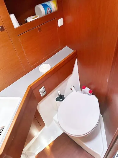 Journey Yacht Photos Pics 2019 Beneteau Oceanis 48 yacht bathroom with wooden cabinetry and modern fixtures.