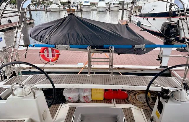 Journey Yacht Photos Pics Beneteau Oceanis 48 (2019) yacht docked, featuring dual steering wheels and covered equipment.