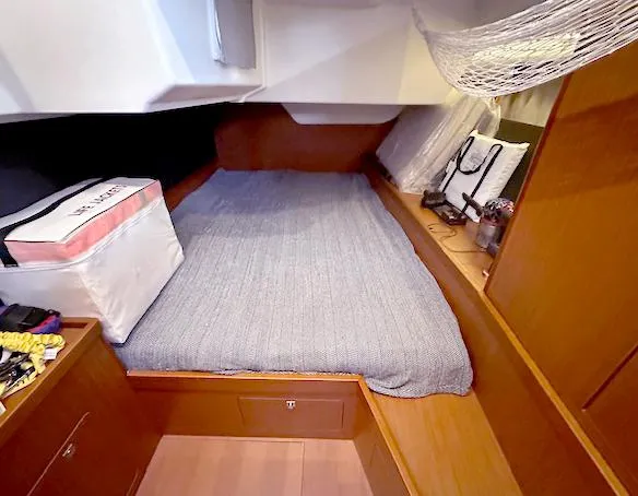 Journey Yacht Photos Pics Cozy cabin interior of 2019 Beneteau Oceanis 48 sailboat with bed and storage.