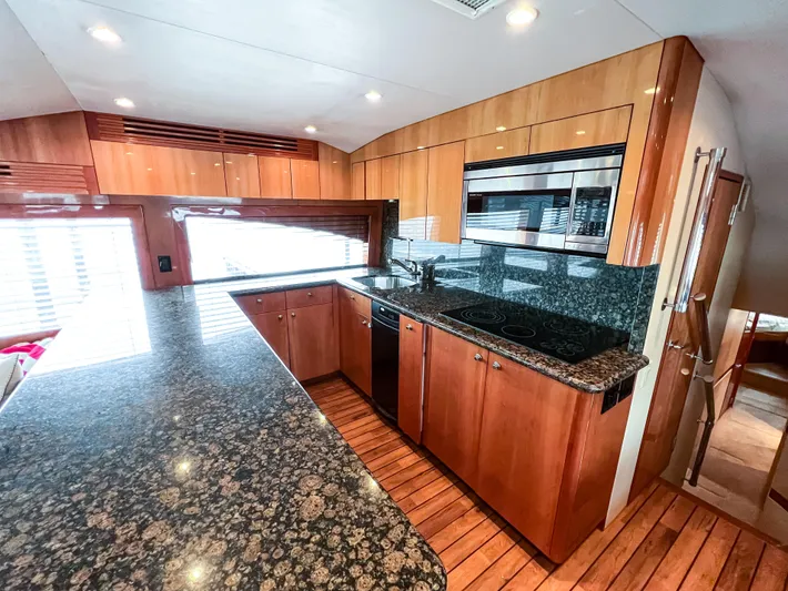  Yacht Photos Pics Luxurious kitchen interior of 2007 Hatteras 68 Convertible yacht with granite countertops.