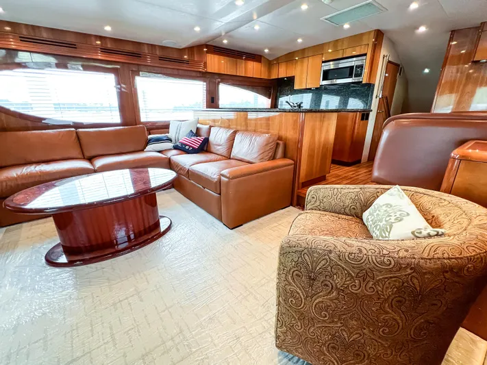  Yacht Photos Pics Luxurious interior of 2007 Hatteras 68 Convertible yacht with leather seating and modern kitchen.