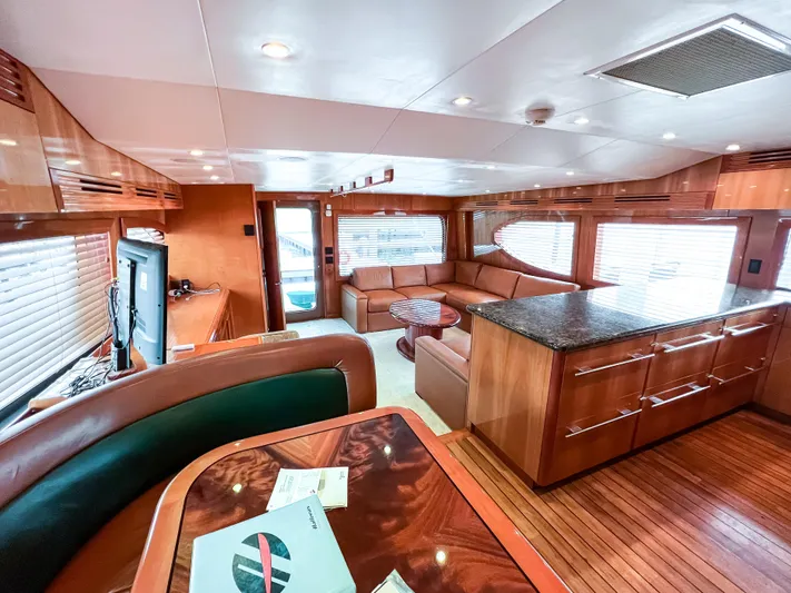  Yacht Photos Pics Luxurious interior of 2007 Hatteras 68 Convertible yacht with elegant wood finishes and spacious seating.
