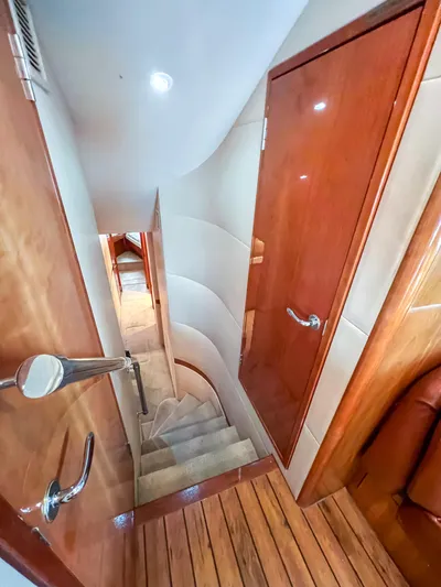  Yacht Photos Pics Interior view of 2007 Hatteras 68 Convertible yacht, featuring wooden stairs and doors.