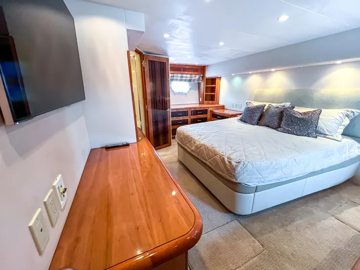  Yacht Photos Pics Luxurious bedroom interior of 2007 Hatteras 68 Convertible yacht with modern furnishings.