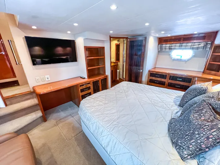  Yacht Photos Pics Luxurious bedroom interior of 2007 Hatteras 68 Convertible yacht with modern amenities.