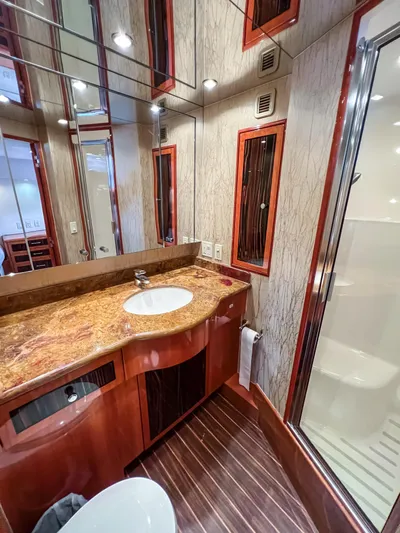  Yacht Photos Pics Luxurious bathroom in 2007 Hatteras 68 Convertible yacht with elegant wood and marble finishes.