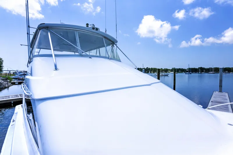  Yacht Photos Pics 2007 Hatteras 68 Convertible yacht docked under a clear blue sky.