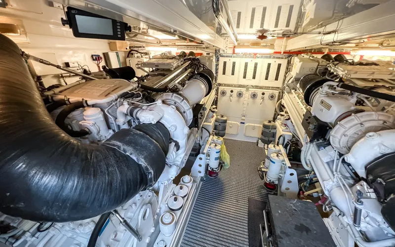  Yacht Photos Pics Engine room of 2007 Hatteras 68 Convertible yacht, showcasing dual engines and mechanical systems.