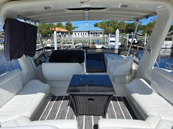  Yacht Photos Pics Luxurious 1997 Navigator 5000 Classic yacht interior with white seating and marina view.