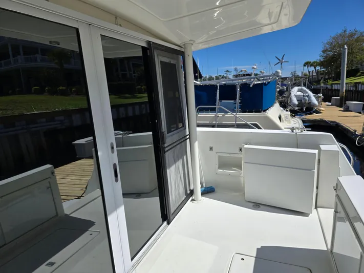  Yacht Photos Pics 1997 Navigator 5000 Classic yacht deck with sliding glass doors and marina view.